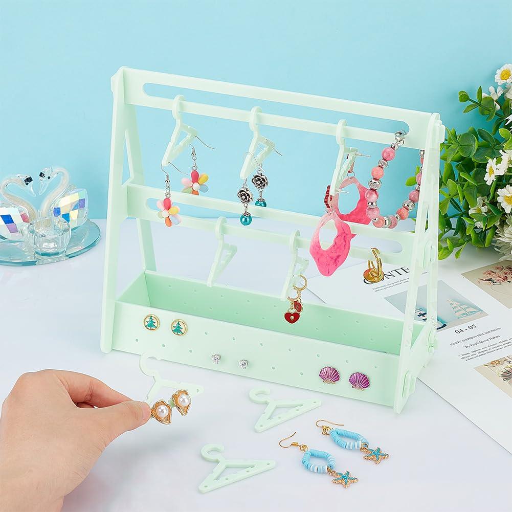 PH PandaHall 68 Holes Earring Organizer with Mini Hangers 2-Tiers Coat Hanger Earring Display Stands for Selling Earring Hanging Acrylic Ear Studs Display Rack for Retail Show Exhibition Green 2