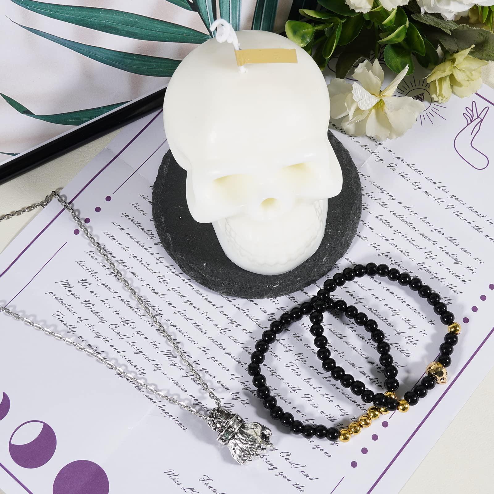 Soulnioi White Skull Candle Scented Soy Wax Candle Burning Time(10-15H), Black Stone Coaster for Candle, 2pcs Obsidian Beaded Bracelets Skull Charm, Antique Silver Fist-Shaped Necklace with Chain 2